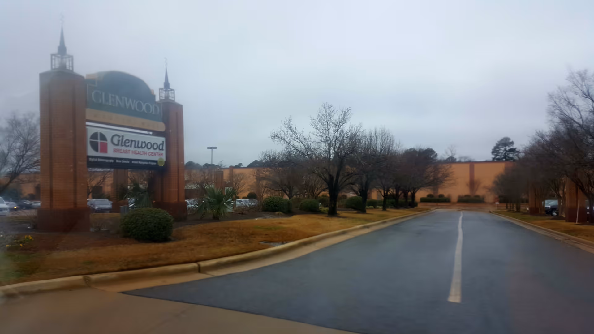 Exterior view of Glenwood Home Health Agency entrance with a tall sign and driveway.
