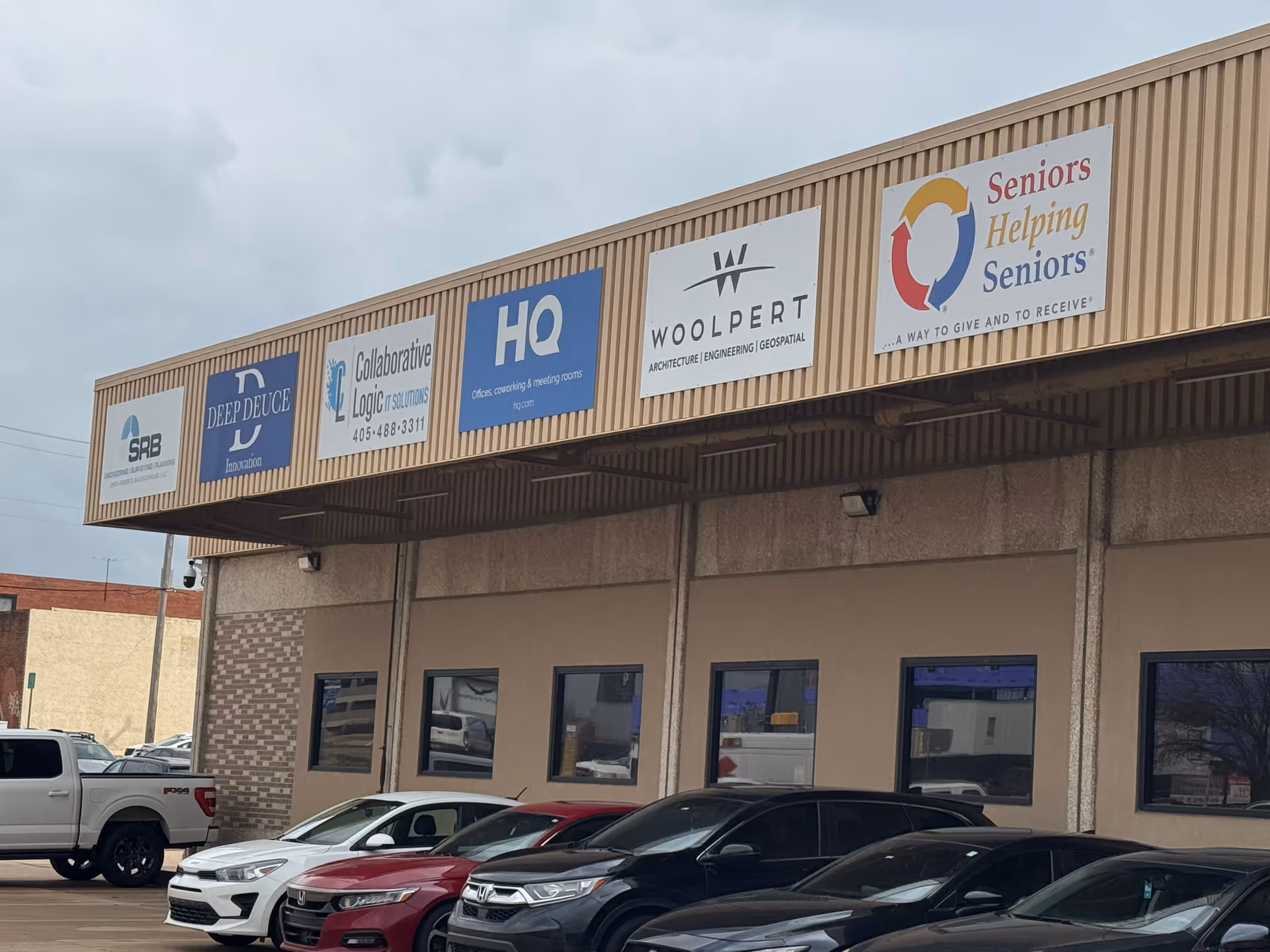 Exterior of a building with multiple business signs, including Seniors Helping Seniors Central Oklahoma
