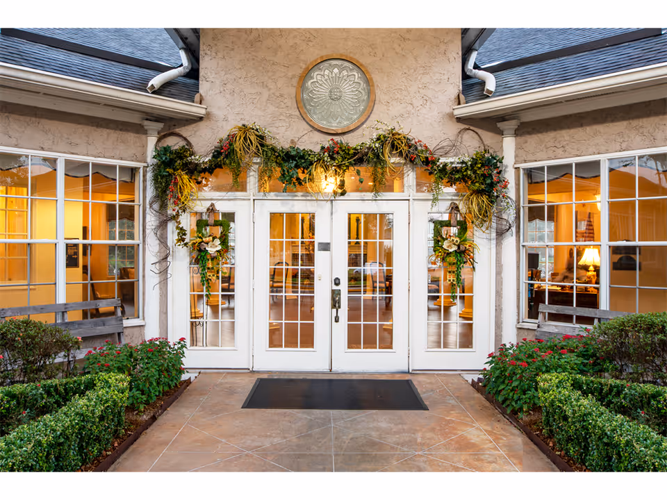 Young's Care Home II entrance with festive garlands and glass doors.