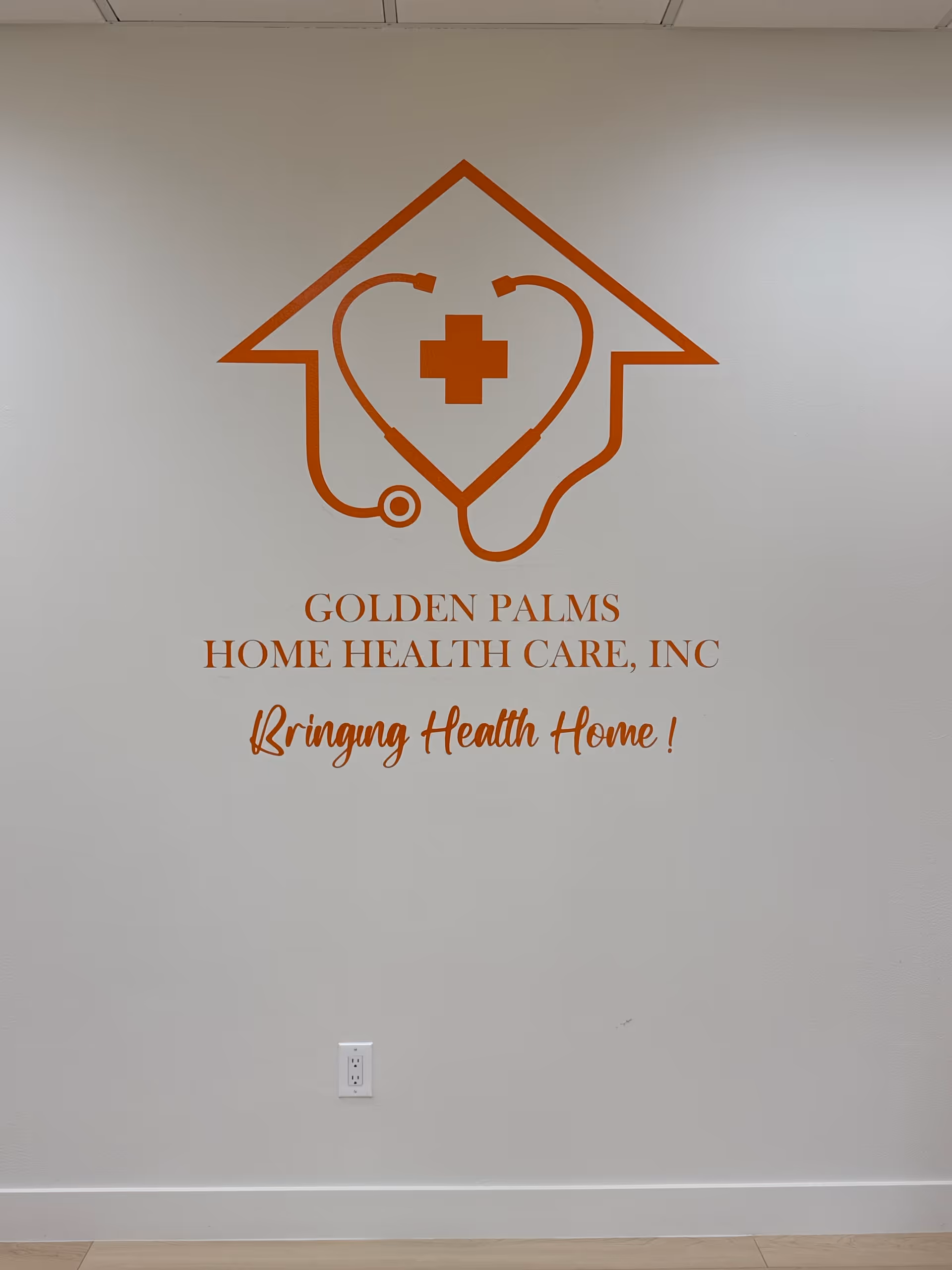 An interior wall featuring Golden Palms Home Health Care logo and slogan in orange.