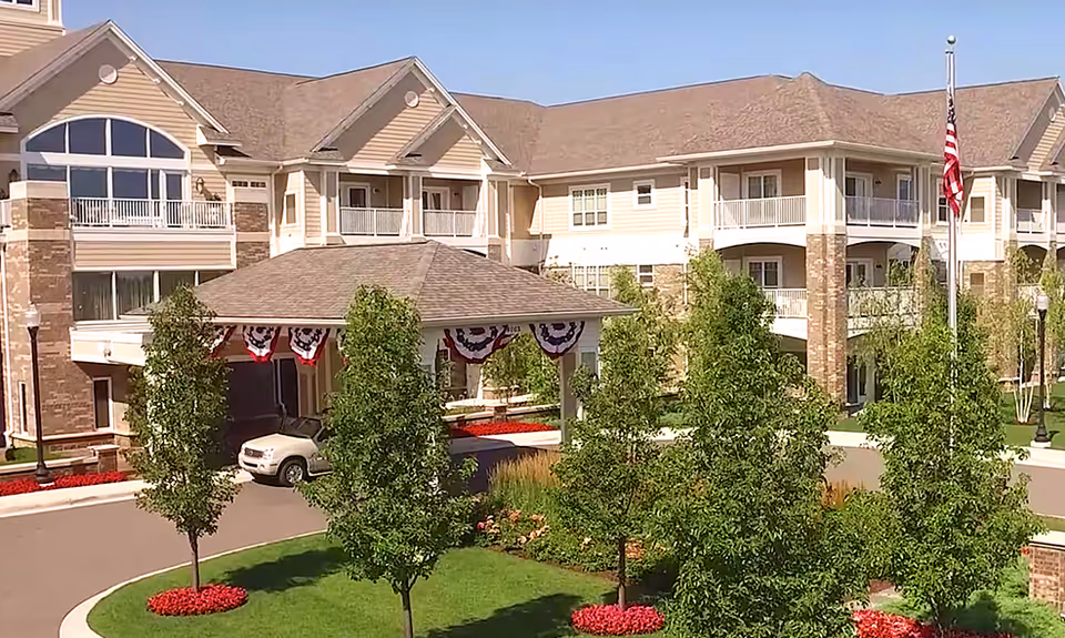 Exterior view of Rose Senior Living Providence Park with entrance canopy and landscaping.