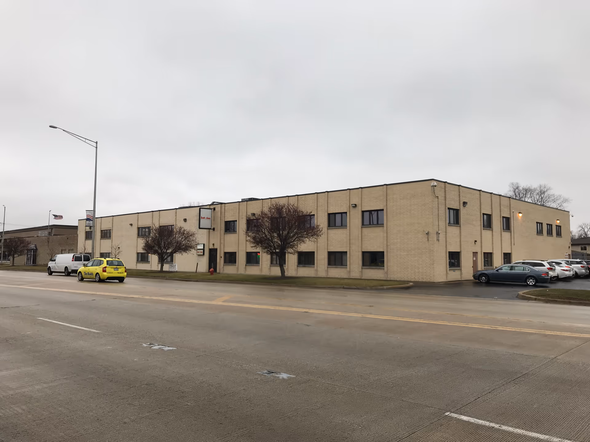 Exterior view of Interim HealthCare of Alsip building along a street with parked cars.