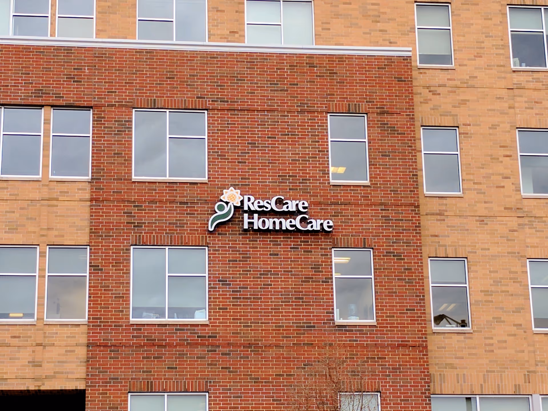 Brick building exterior with a ResCare HomeCare sign on the front facade.