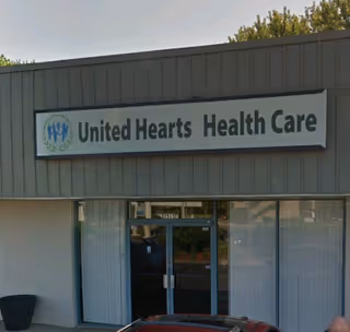 Front exterior of United Hearts Health Care building with sign and glass entrance.