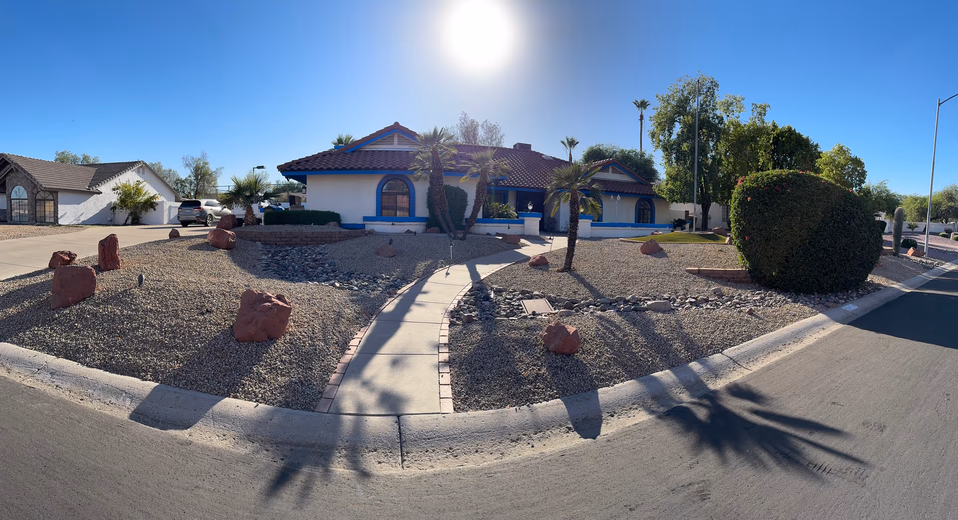 Front exterior of Vandermeyer Senior Living LLC, blue-trimmed building with desert landscaping.