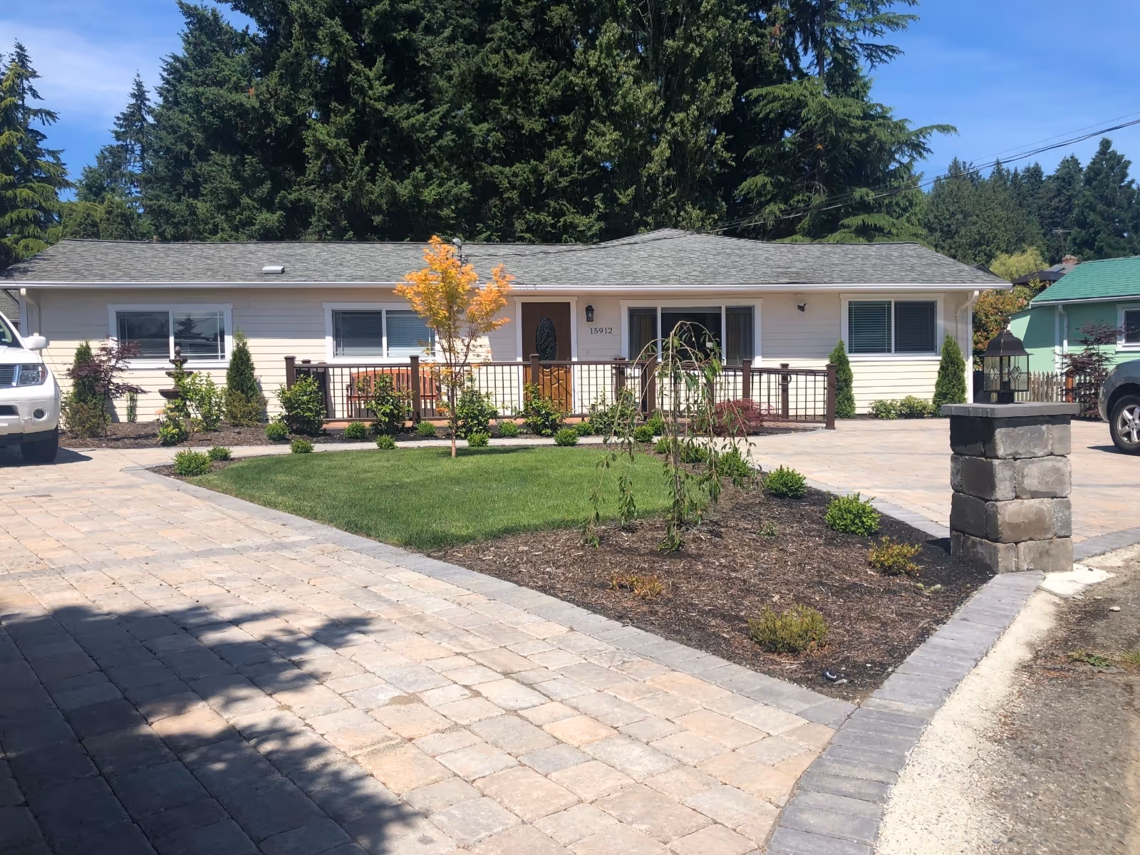 Front view of a single-story beige senior home with a paved driveway