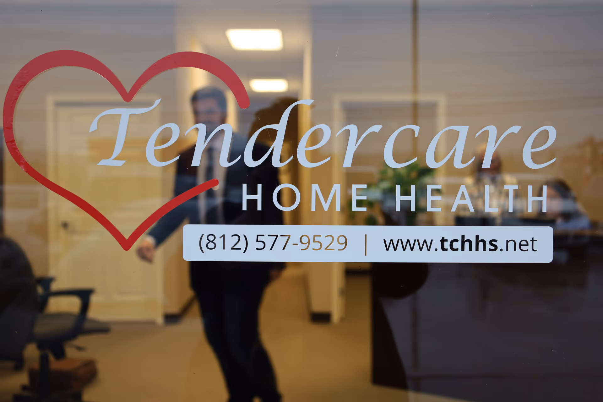 Glass door displays Tendercare Home Health logo with heart, interior lobby visible.
