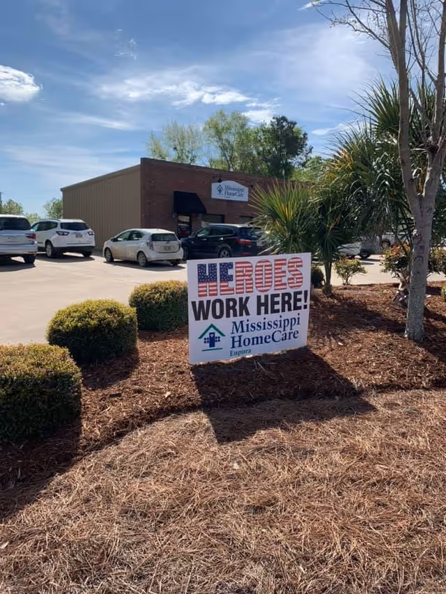 Exterior view of Mississippi HomeCare Eupora facility with a patriotic 'Heroes Work Here' sign.