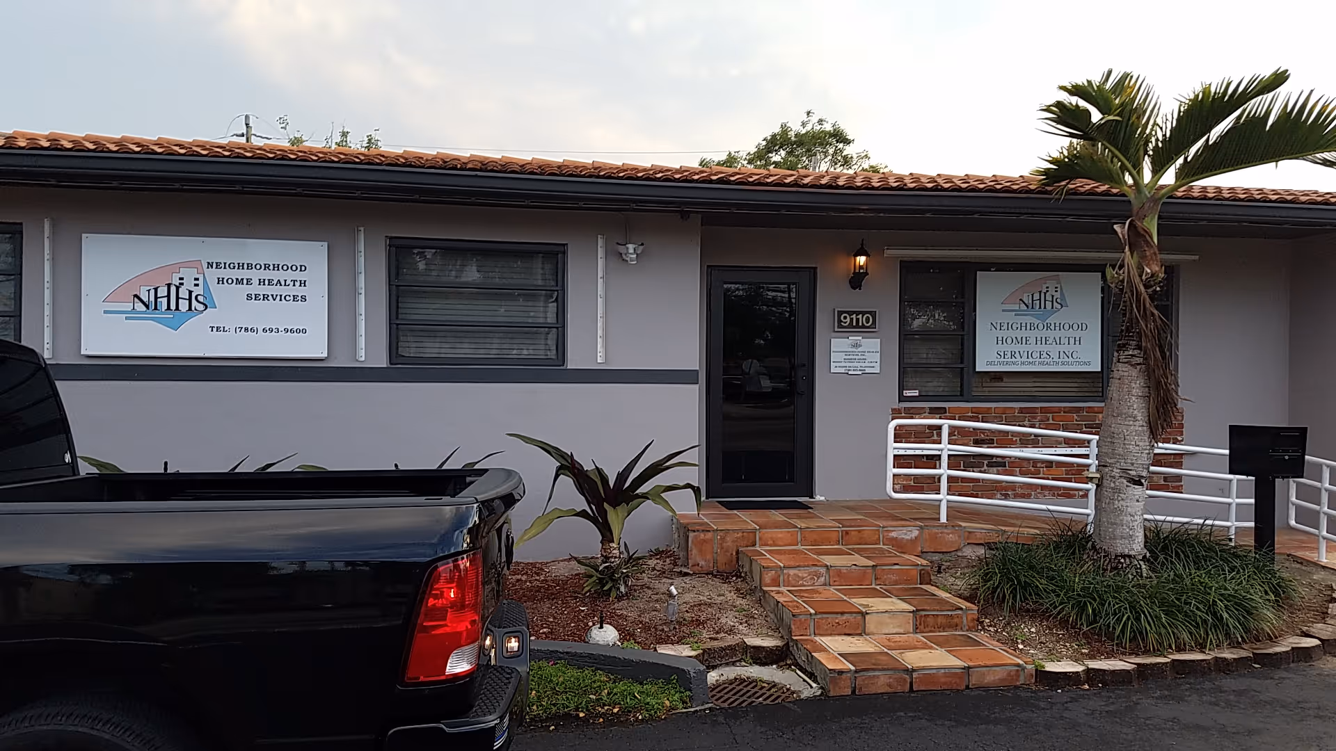 Exterior view of Neighborhood Home Health Services building entrance with steps and signage.