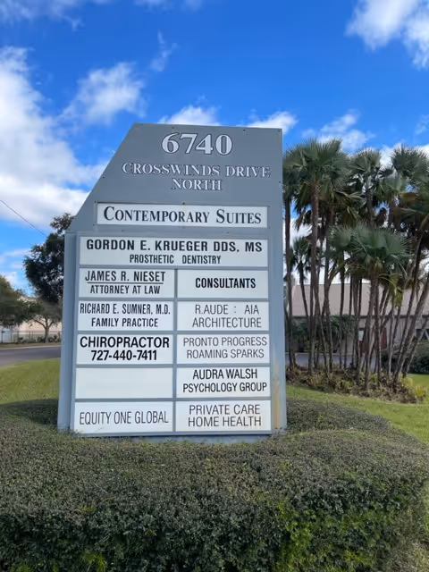 Outdoor signboard listing multiple tenants, including Private Care Home Health.