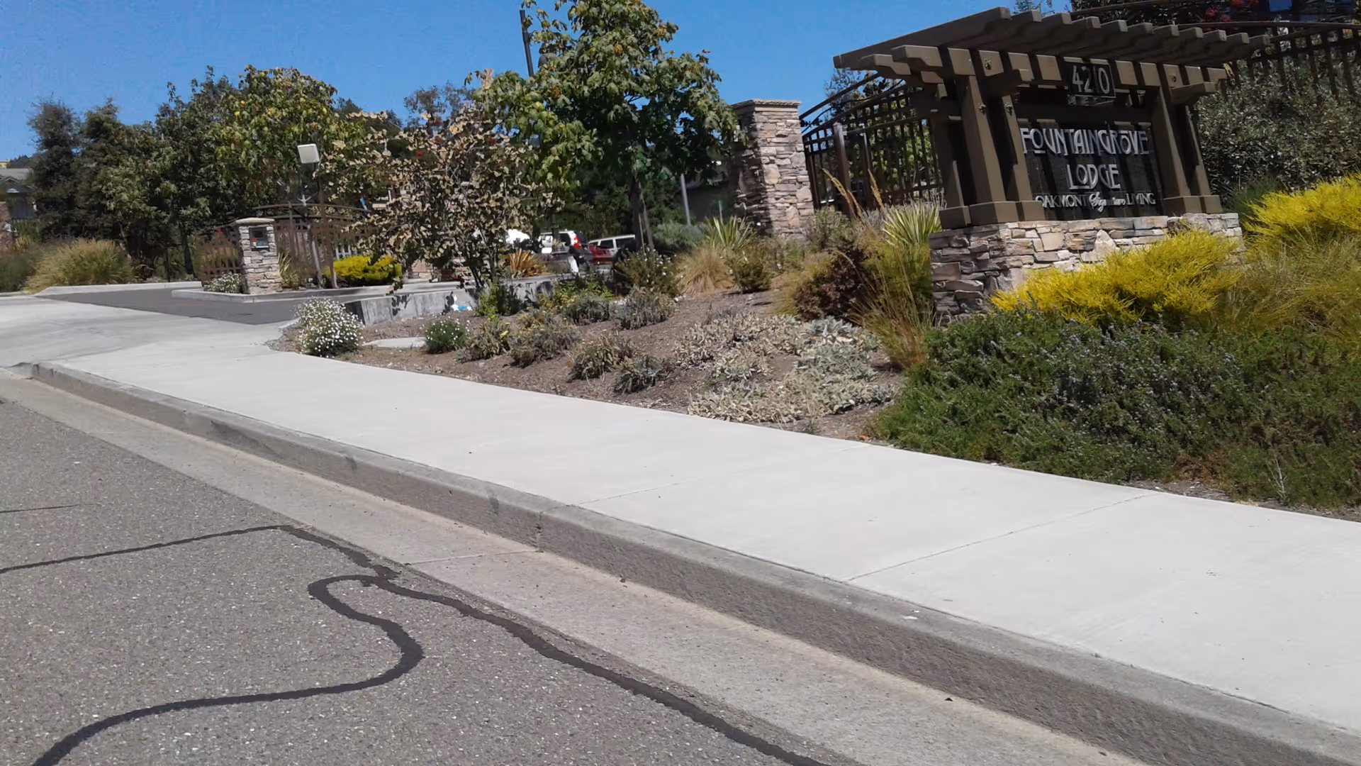 Exterior view of Fountaingrove Lodge entrance with landscaping and sign.