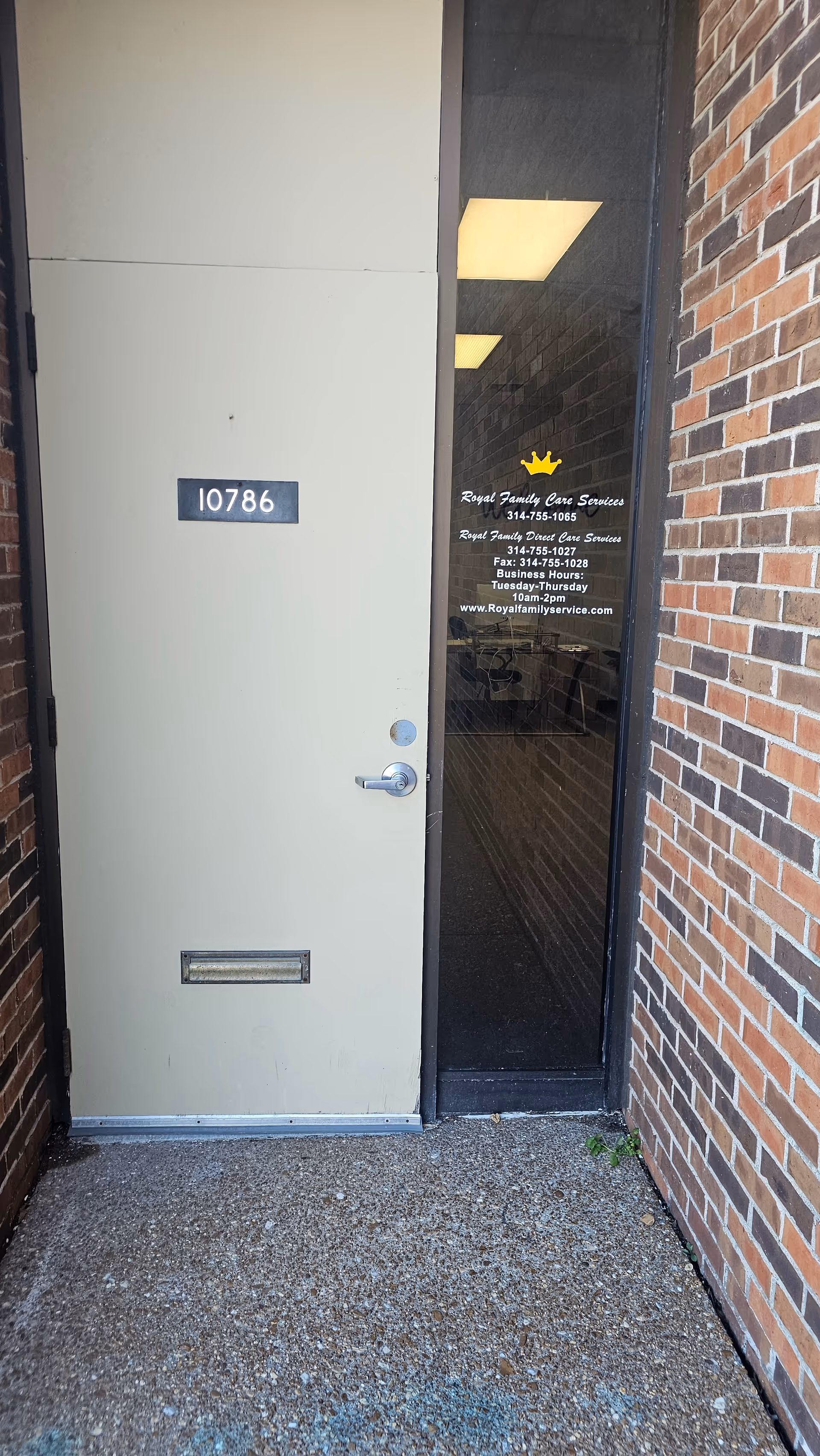 Front entrance to Royal Family Services building with brick walls and glass entry door.