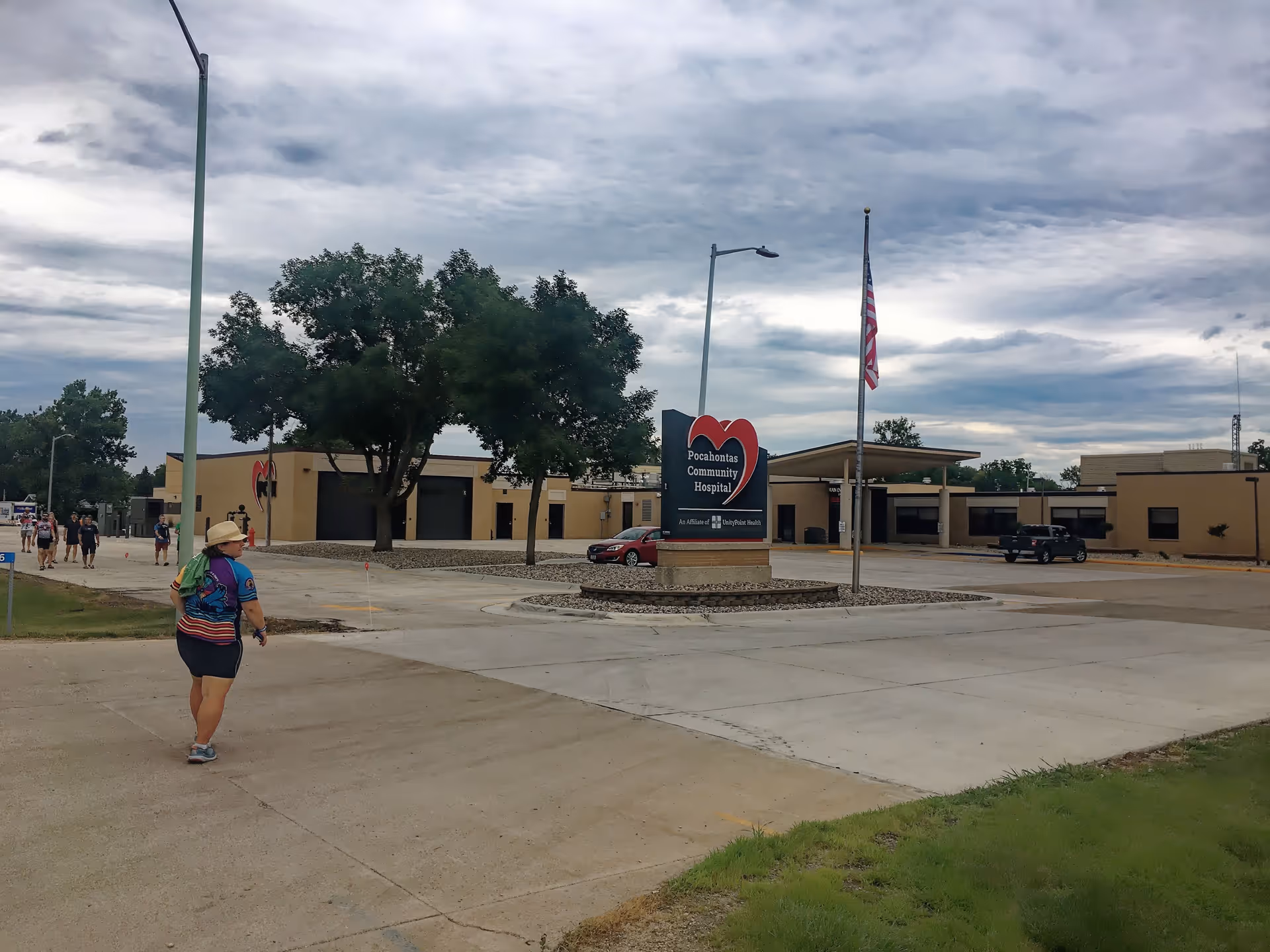 Exterior view of Pocahontas Community Hospital with a heart sign and parking lot.