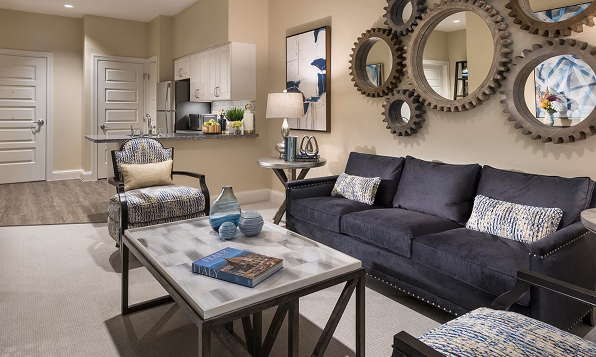 Modern living room inside The Preston of the Park Cities with sofa, chairs, and coffee table.