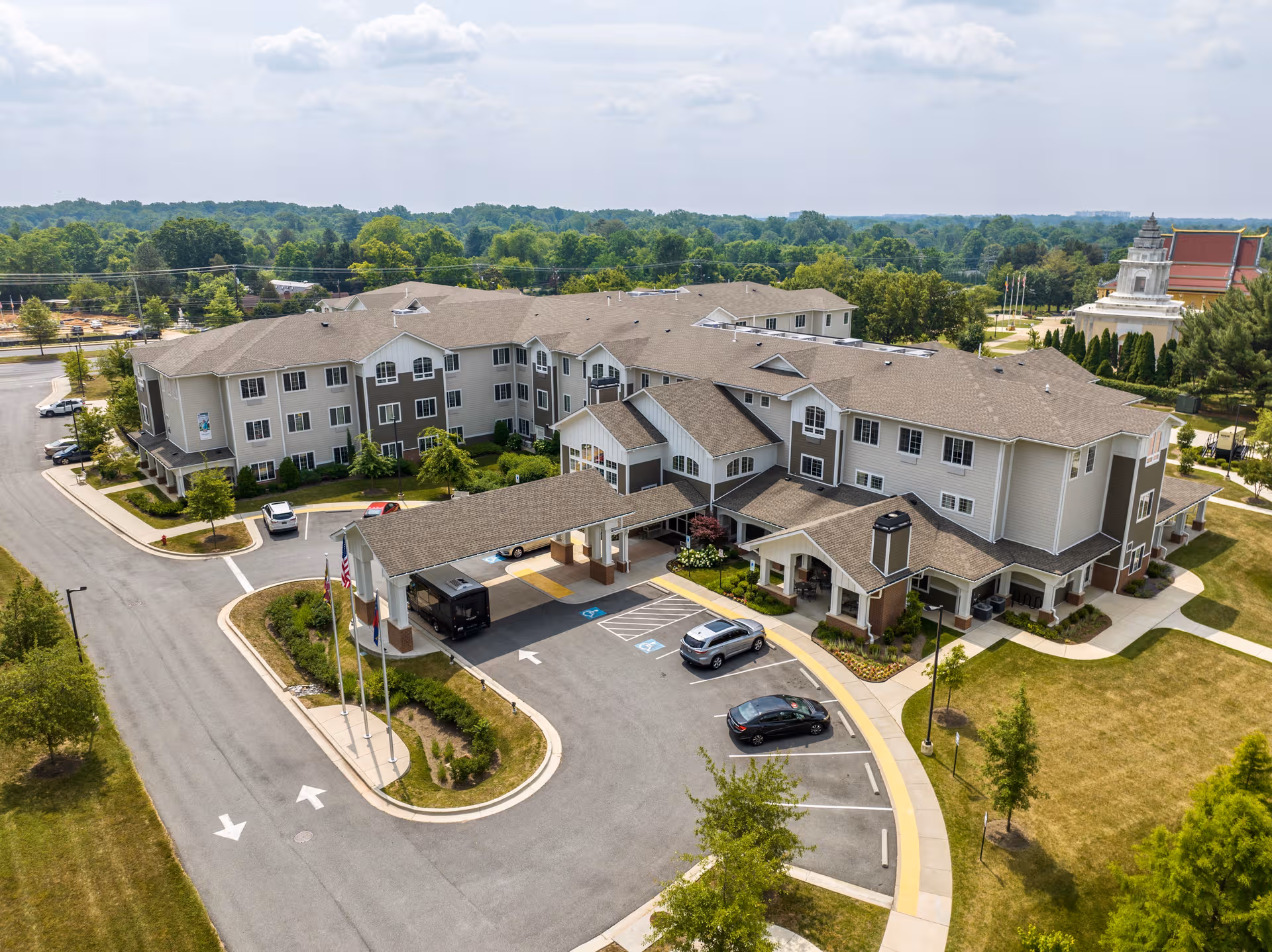 Aerial view of a multi-wing senior living facility with parking and landscaping.