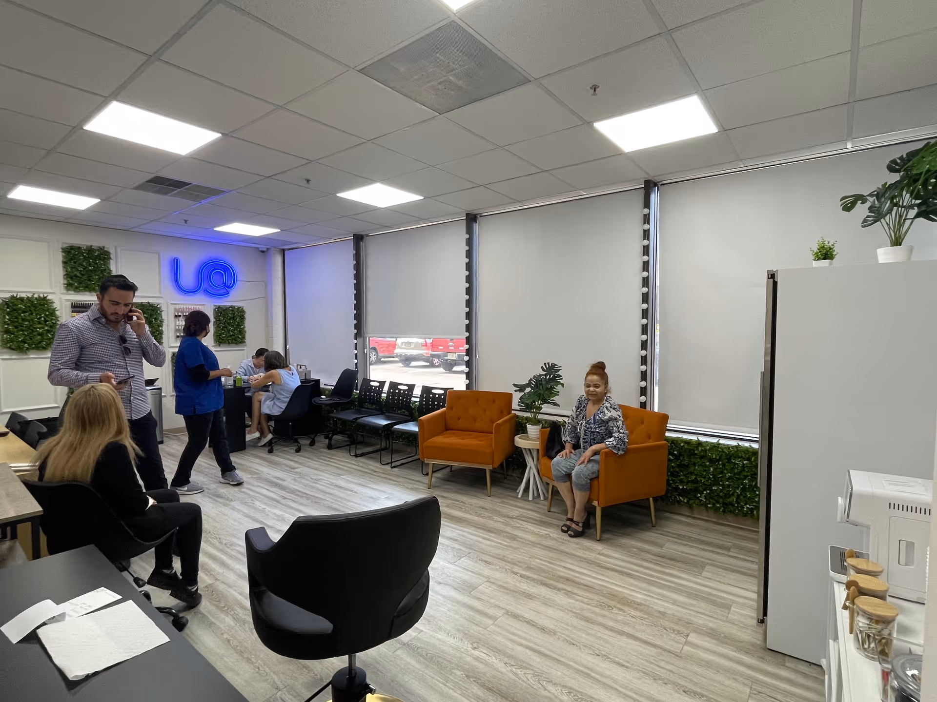 Interior lobby of a home health agency with seating, staff, and clients.