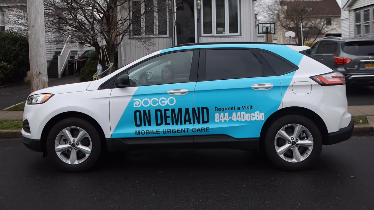 A DocGo on-demand mobile urgent care van parked on a residential street.