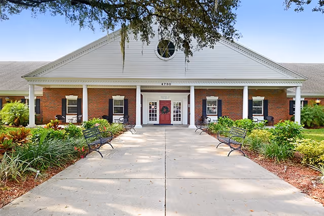 Brookdale Colonial Park exterior with brick facade, columns, and landscaped walkway.