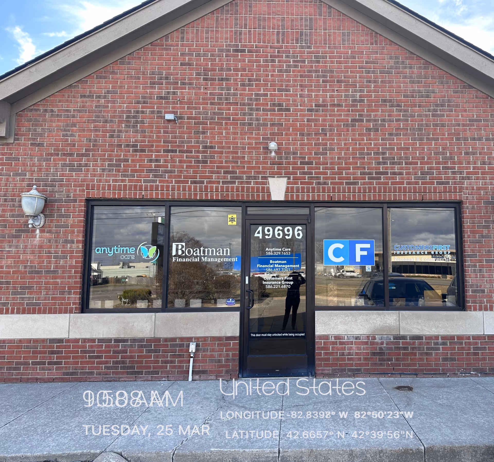 Brick storefront with large windows and a central door displaying Anytime Care signage.