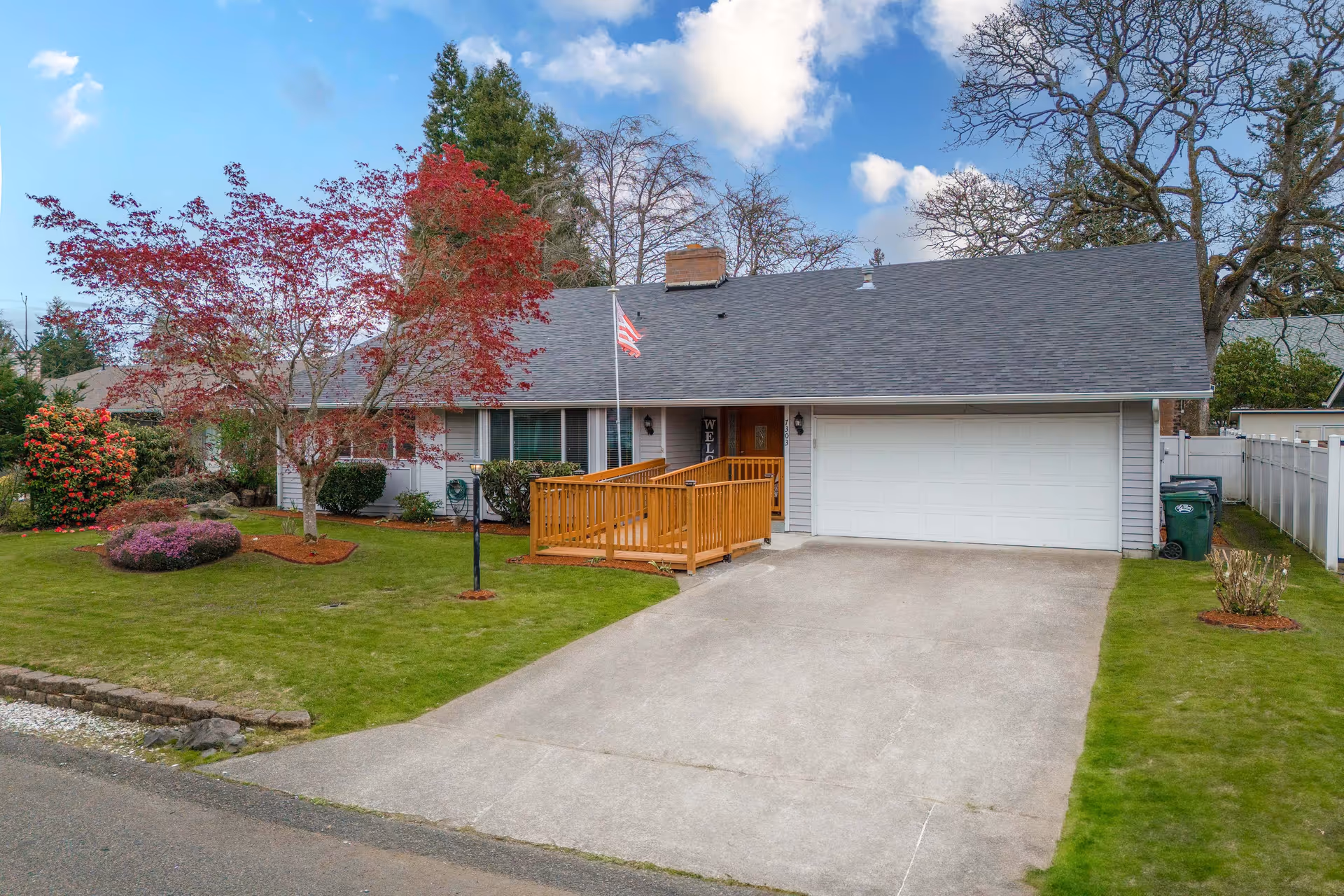 Front view of a single-story home-like facility with a ramp and a well-kept lawn.