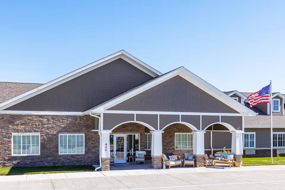 Exterior view of Edencrest at Siena Hills entrance with outdoor seating on a covered porch.