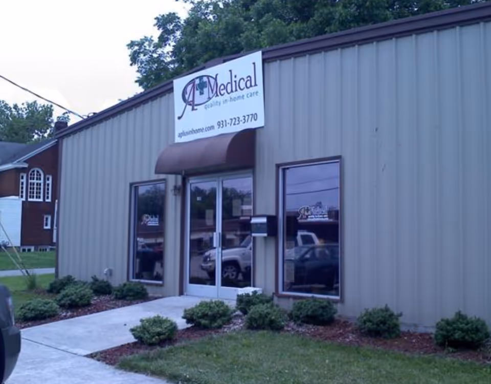 Exterior view of a small building with a glass entrance and A Medical sign.