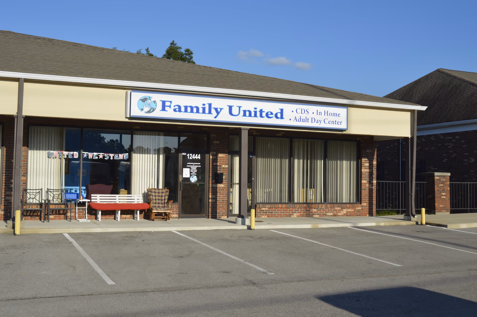Exterior view of a single-story senior care facility with a sign reading Family United.