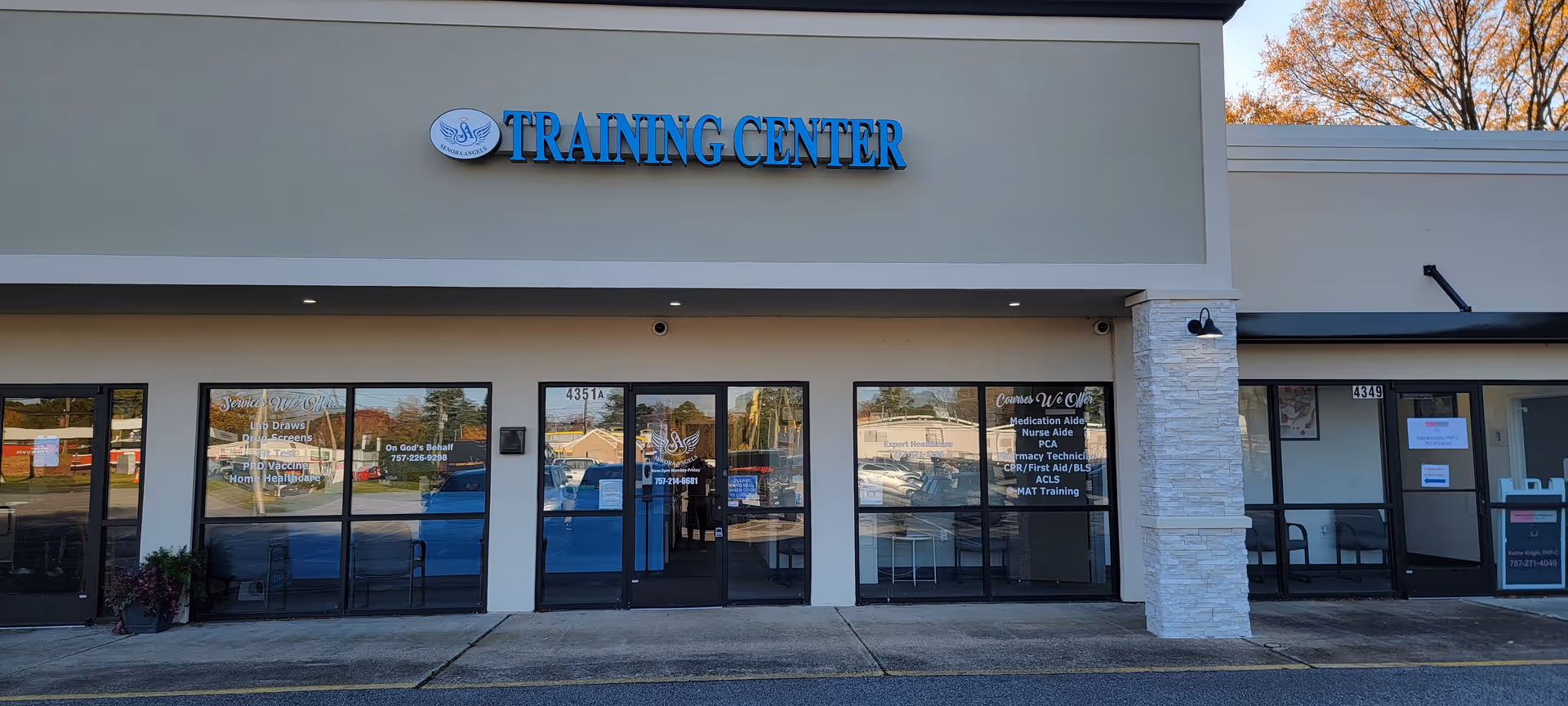 Exterior view of a building with a Training Center sign and glass storefronts.