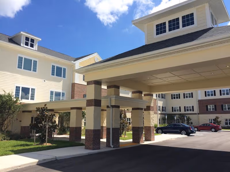 Exterior view of Volante of Fort Myers with a covered entrance and parked cars.