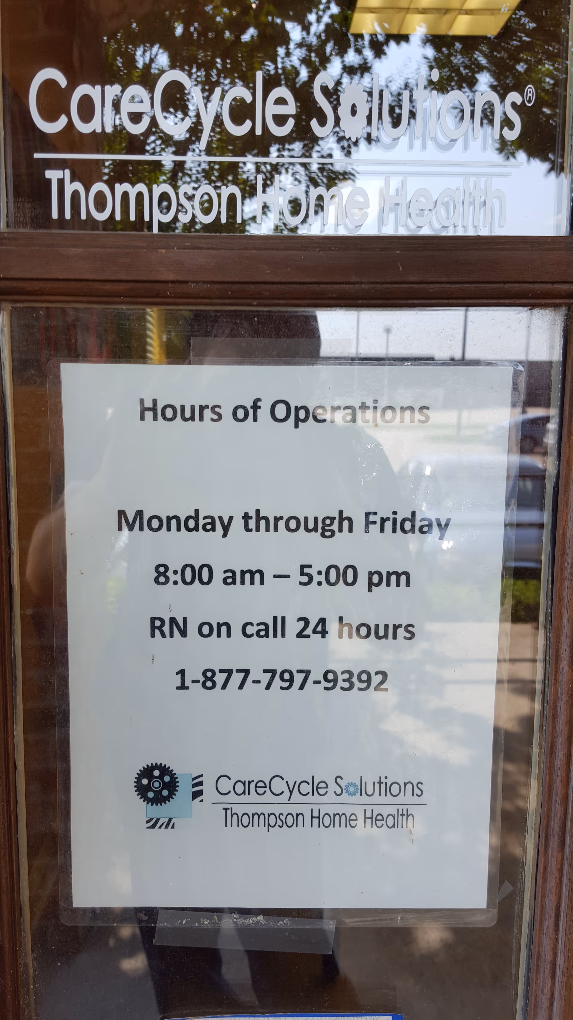 Glass door sign shows CareCycle Solutions and Thompson Home Health hours of operation