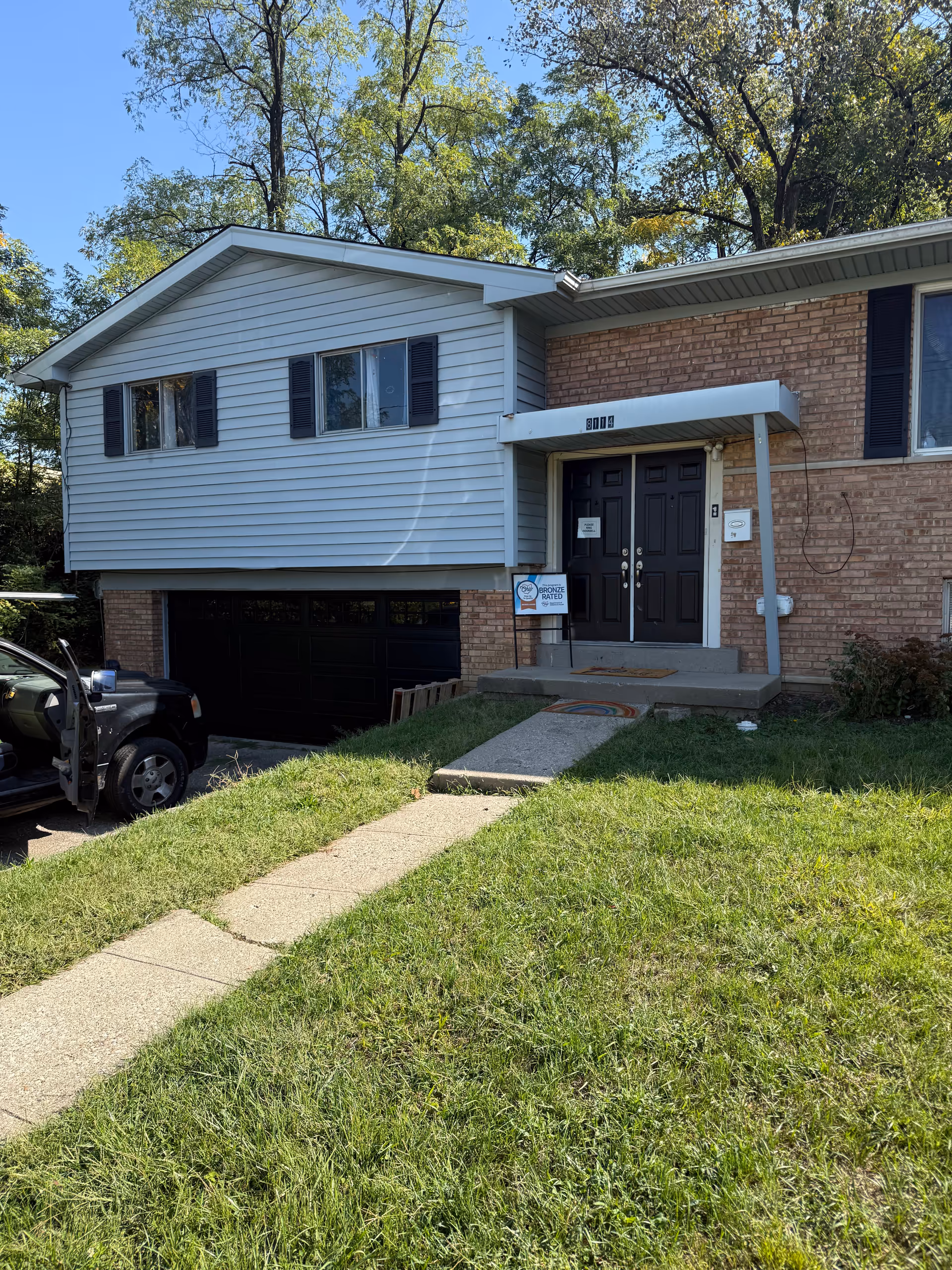 Exterior view of a two-story building with a front entrance and driveway.
