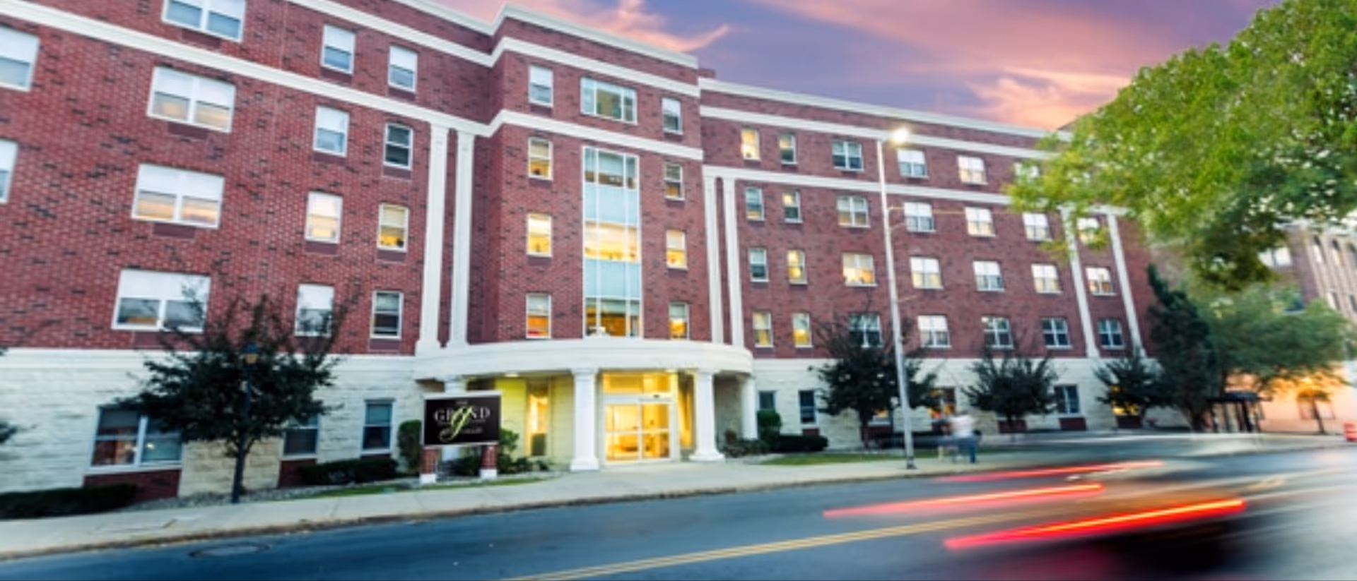 Exterior view of The Grand Rehabilitation and Nursing at River Valley building with entrance.