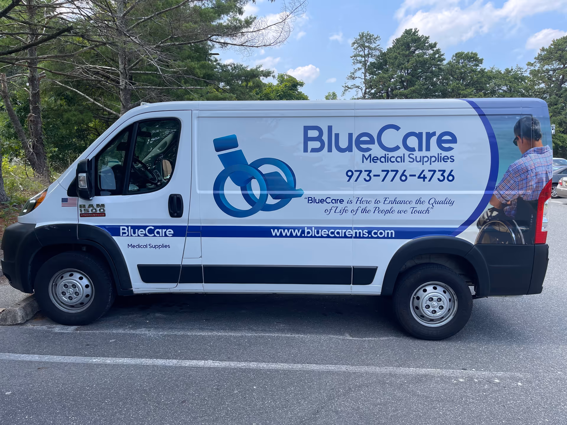 White van with BlueCare Medical Supplies branding and wheelchair logo parked in a lot.