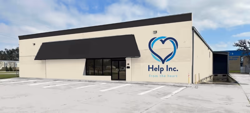 Exterior view of In Home Care by Help, Inc. building with heart logo.