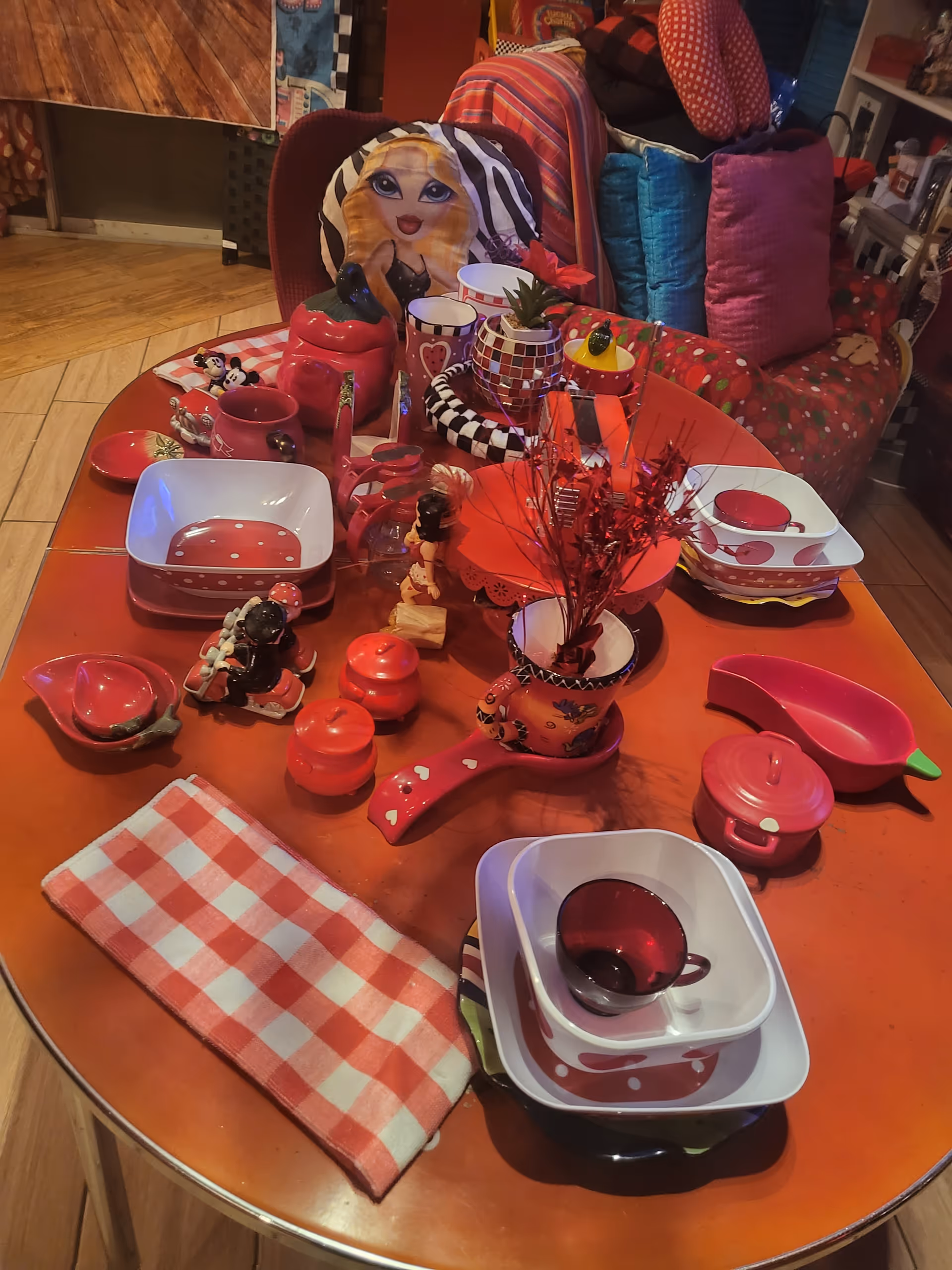 Colorful children's toy tea set on a wooden table in a cozy living room.