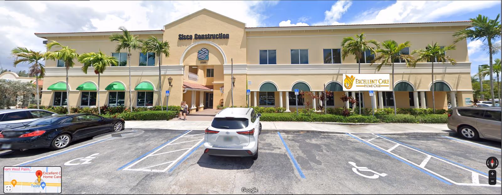 Exterior view of Excellent Care Home Care facility with palm trees and a parking lot.