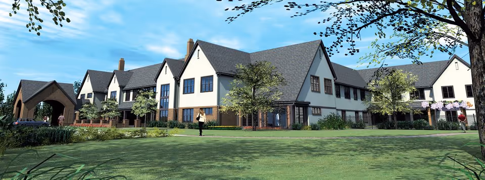 Exterior view of Lodge Lane Assisted Living, a long building with pitched roofs and green lawn.