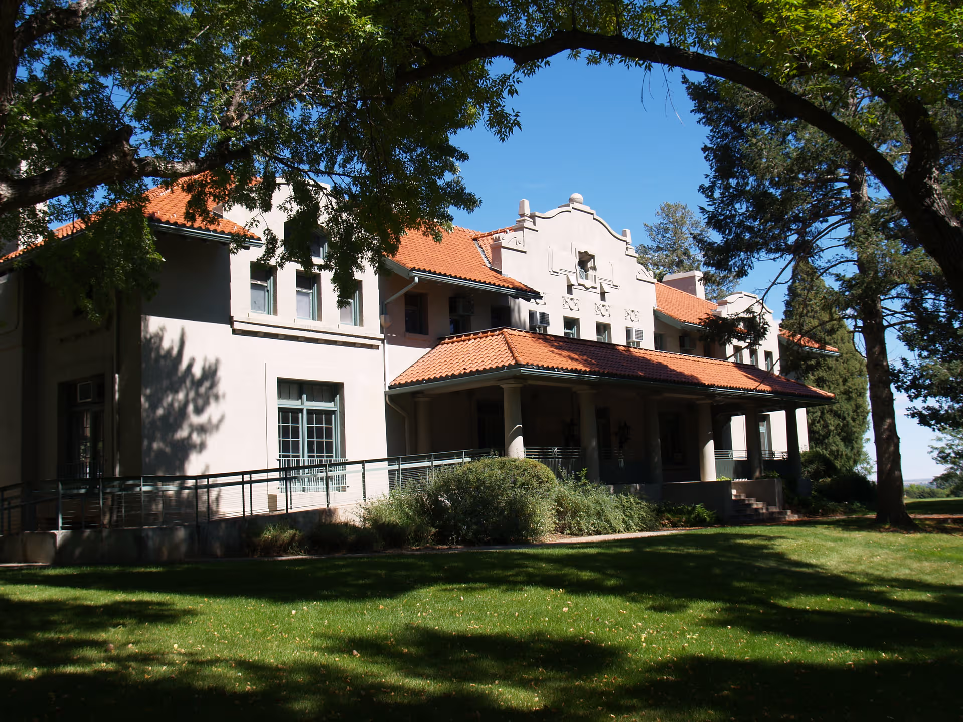 Front exterior of Myron Stratton Home showing beige building with a red-tiled roof.