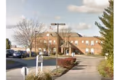 Exterior view of Bayview Health Care building with walkway, landscaping, and parked cars.
