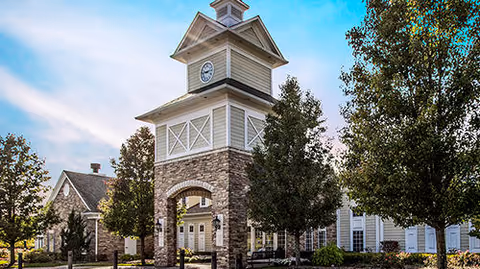Front exterior of Bridgewater Brownstown facility with a clock tower and stone facade.