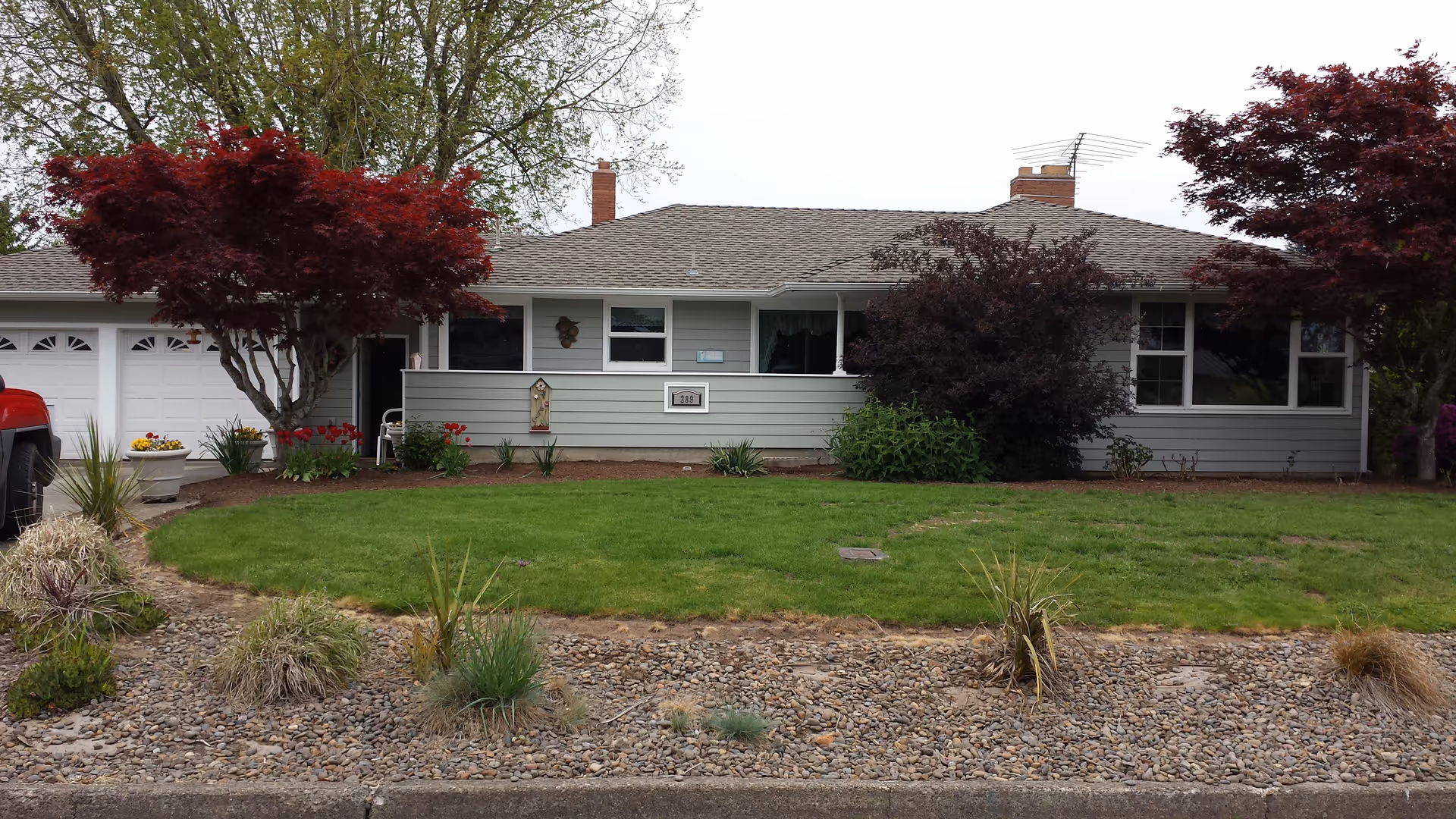 Front view of Apple Blossom Manor, a single-story ranch house with landscaped yard.