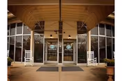 Entrance of Mitchell-Hollingsworth Nursing and Rehabilitation Center with glass doors and canopy.