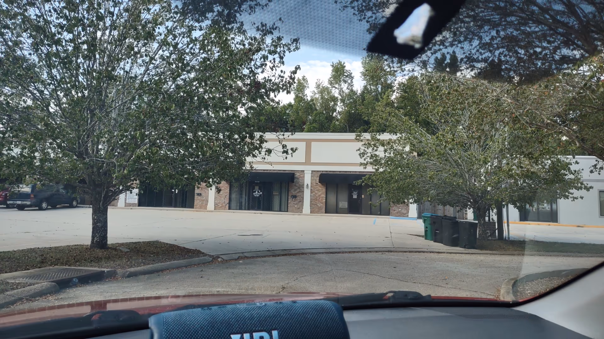 Exterior view of Island Home Care building with trees, parking, and entrance doors.