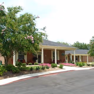 Exterior view of Dublin Square senior living facility with brick facade and landscaped front.