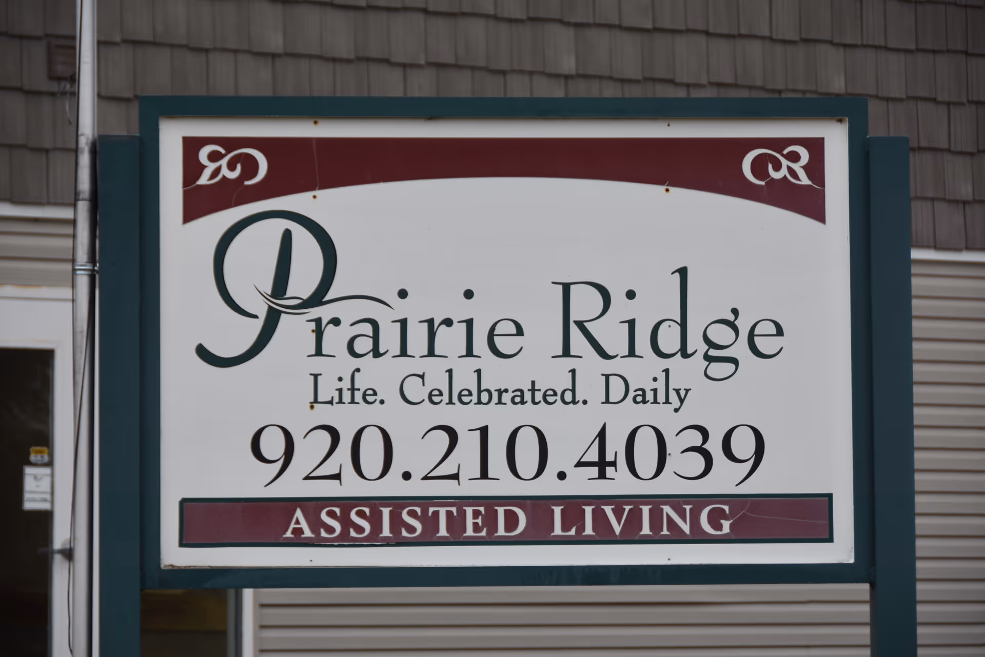 Exterior sign for Prairie Ridge Assisted Living on a building facade.