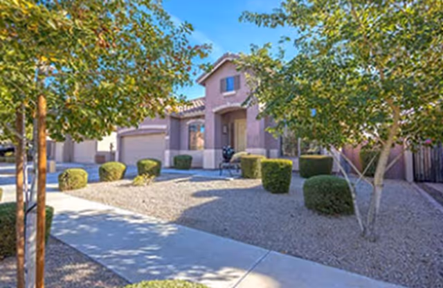 Front exterior view of a two-story senior housing facility with desert landscaping.