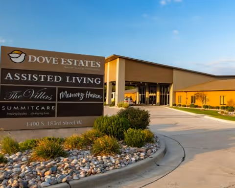Exterior view of Dove Estates Assisted Living entrance with landscaped grounds.