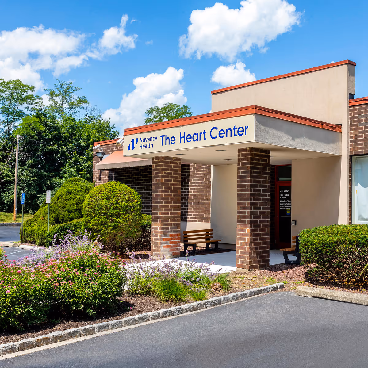 Exterior view of Nuvance Health The Heart Center with brick columns and landscaped surroundings.