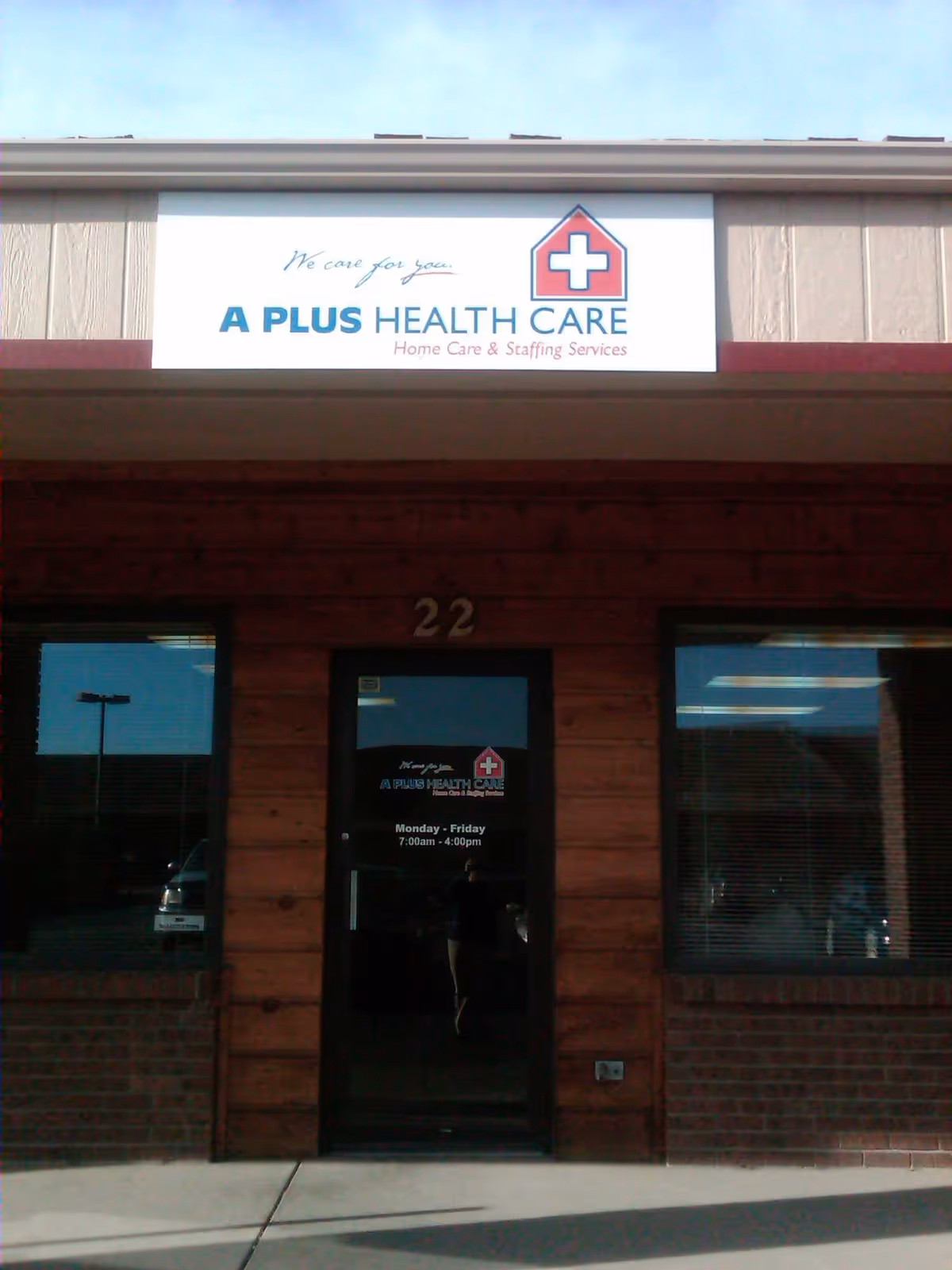 Exterior view of A Plus Health Care storefront with sign and glass entrance door.