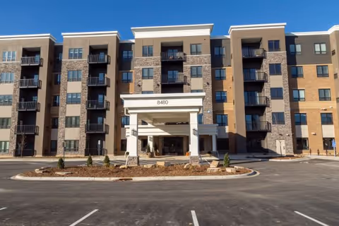 Front view of Eden Prairie Senior Living's modern multi-story building with covered entrance.